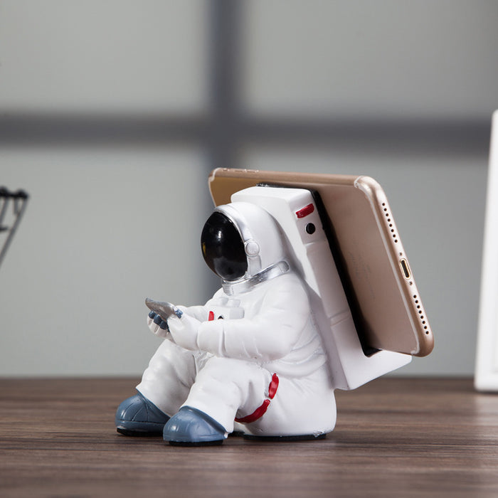 Søt mobilholder med astronautmotiv for skrivebordet, enkel romfarholder
